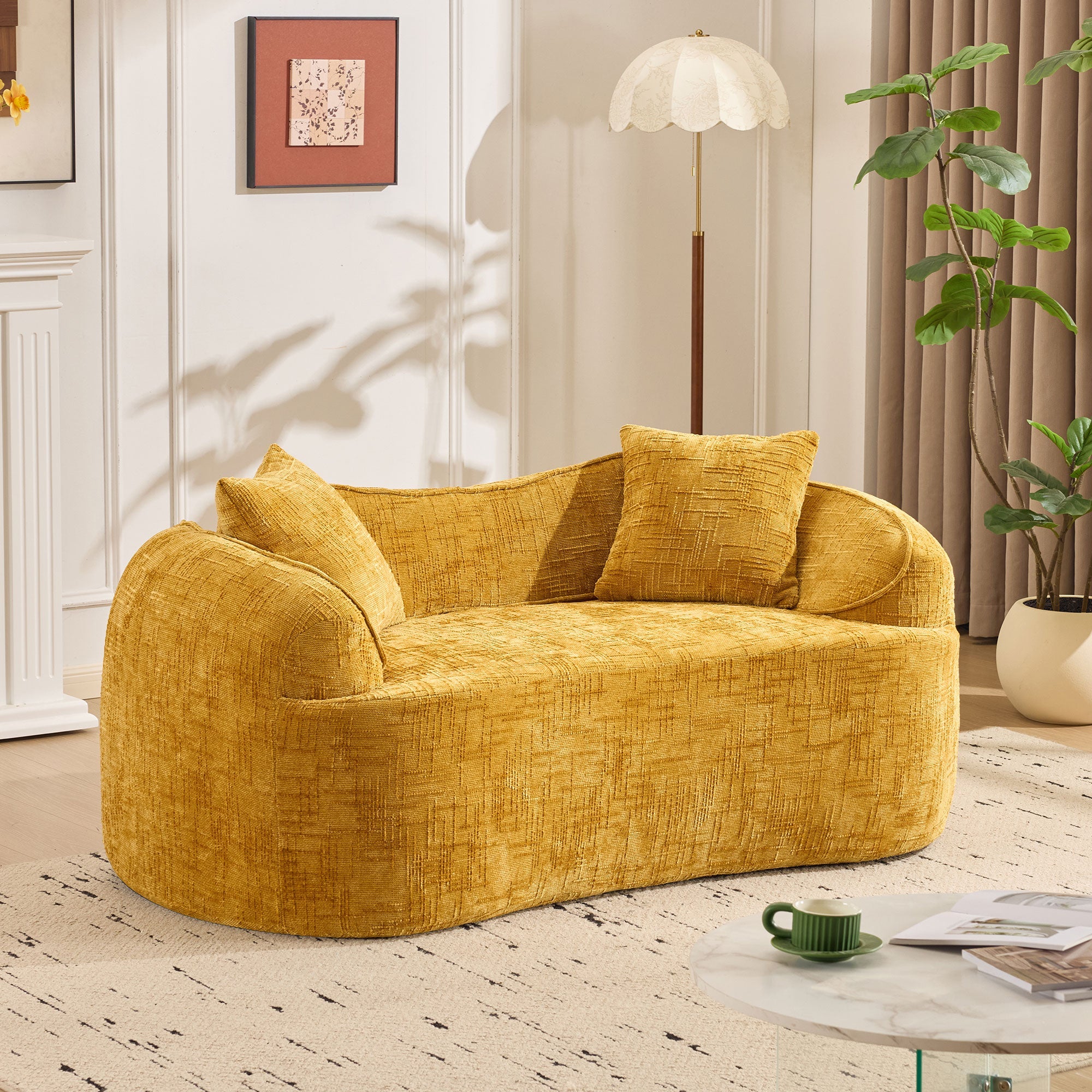 Yellow curved two-seater sofa with armrests and 2 cushions, cream-colored