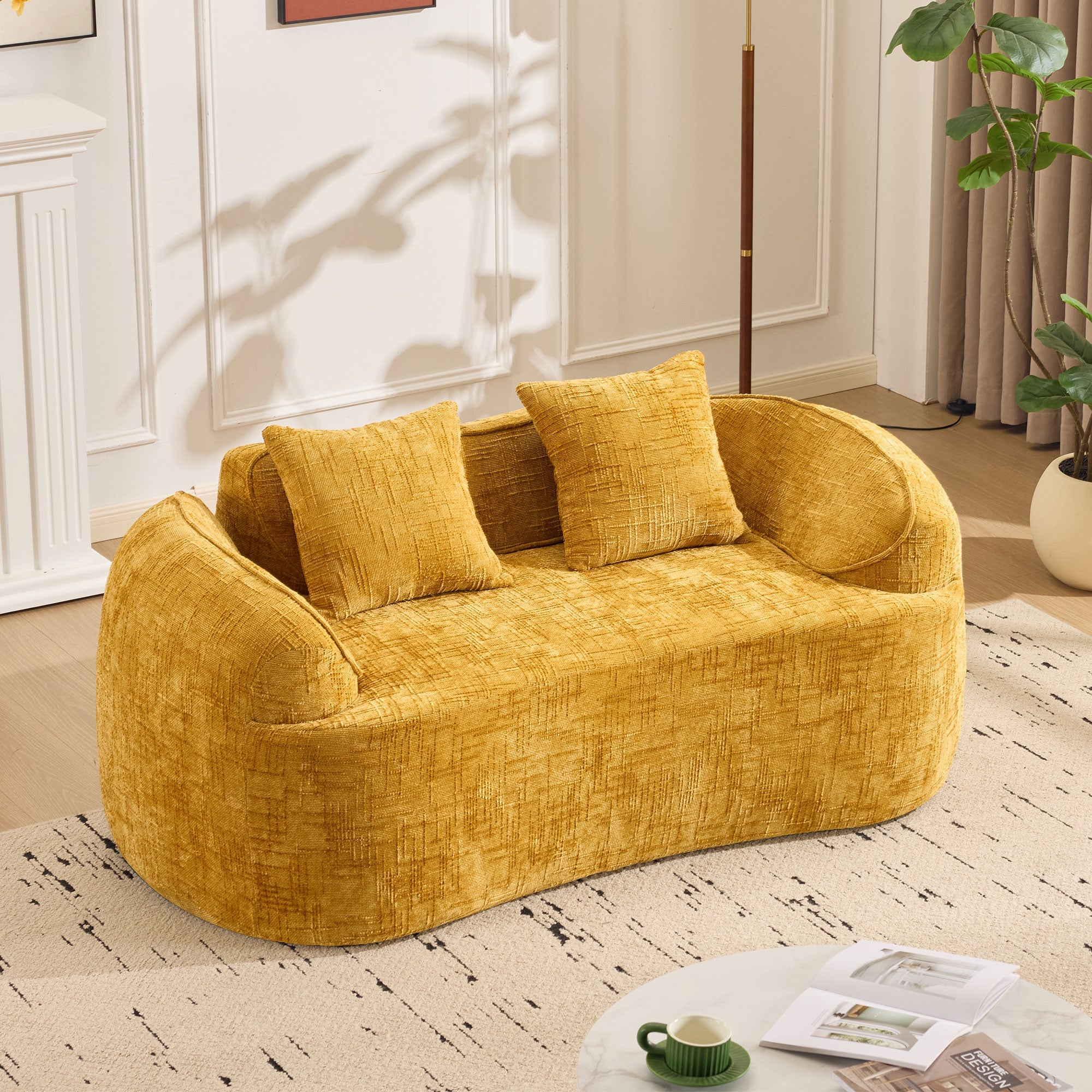 Yellow curved two-seater sofa with armrests and 2 cushions, cream-colored