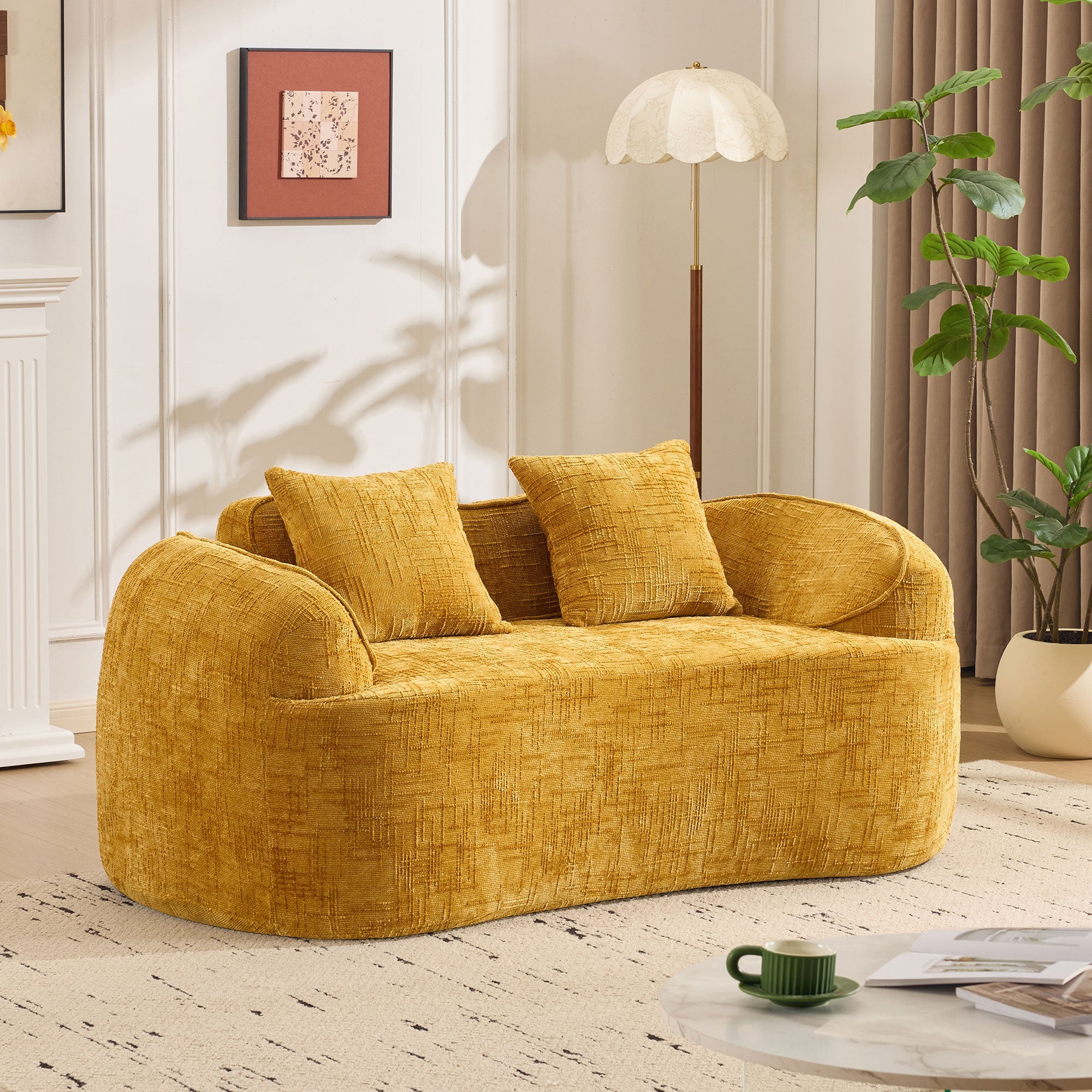 Yellow curved two-seater sofa with armrests and 2 cushions, cream-colored